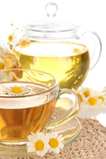 Cup of herbal tea with camomiles close up