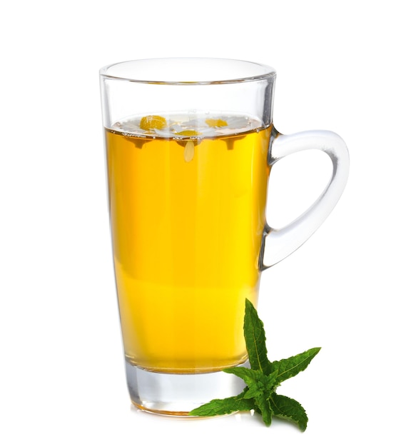 Cup of herbal tea with chamomile flowers and mint on white background