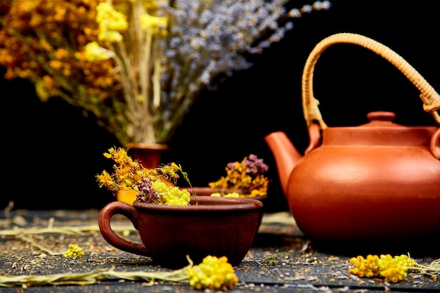 Cup of herbal tea with teapot