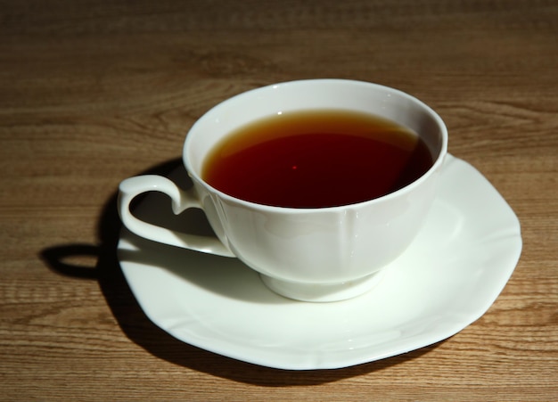 Cup of hot beverage on wooden table