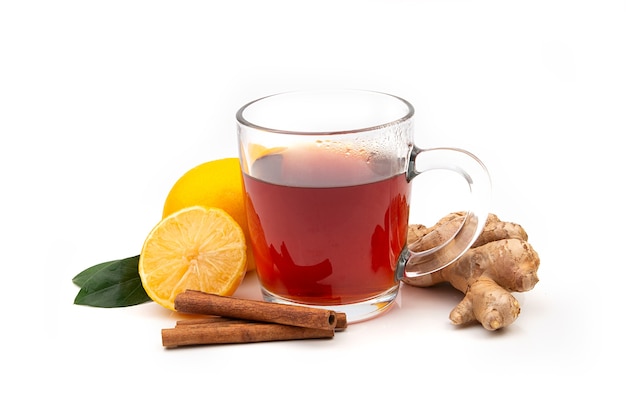 A Cup of hot black or green tea with lemon and ginger on a white background. Ingredients against influenza and viruses. Natural medicine.