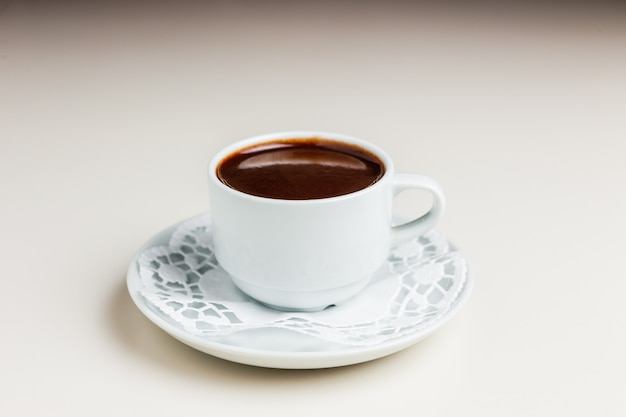 Cup of hot chocolate on a saucer and napkin