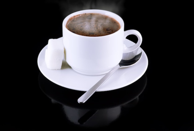 Cup of hot chocolate, sugar, on a black background.