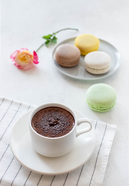 Cup of hot chocolate with macarons flowers