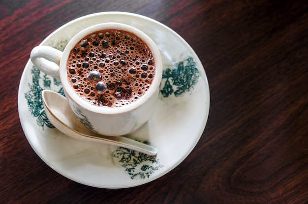 Cup of hot chocolate on wooden surface