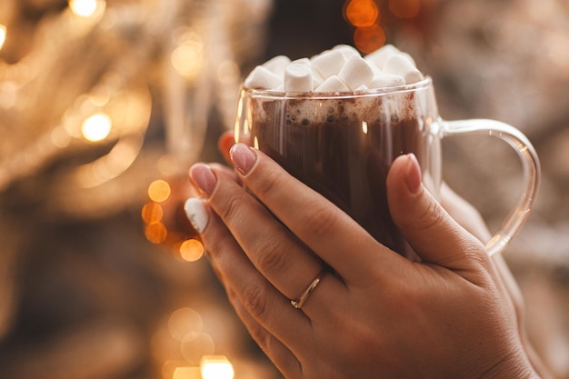 Cup of hot cocoa on Christmas background Hot drink with spices and sweets Christmas concept