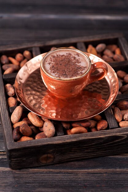 Cup of hot cocoa and cocoa beans Organic products