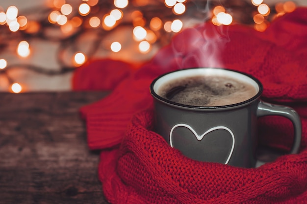 A cup of hot cocoa and a warm knitted sweater.