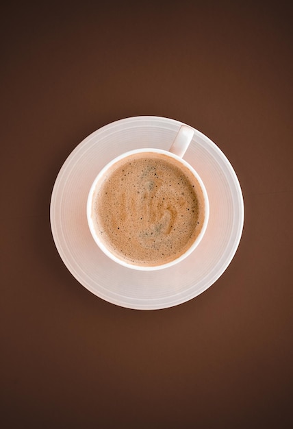 Cup of hot coffee as breakfast drink flatlay cups on brown background