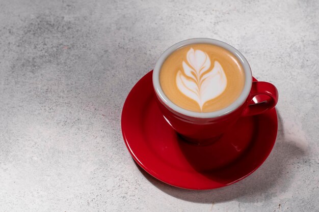 Photo cup of hot coffee latte on white table