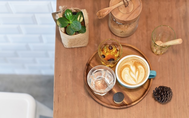 A cup of hot coffee with bakery on wooden table