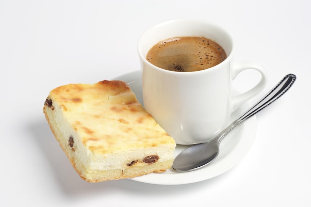 Cup of hot coffee with cheesecake on white background