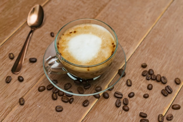 Cup of hot coffee with milk on a dark surface. latte or cappuccino on a wooden table with copy space