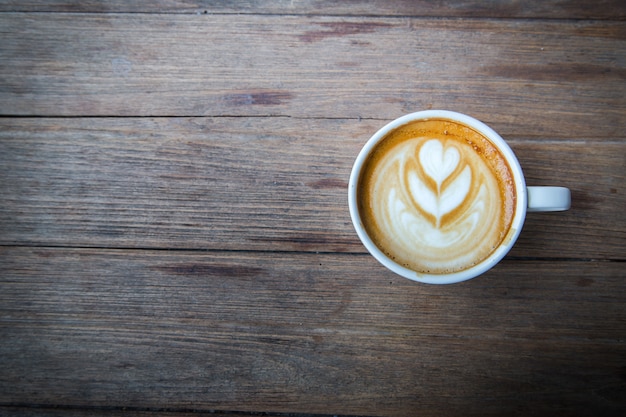 cup of hot coffee on wood table background