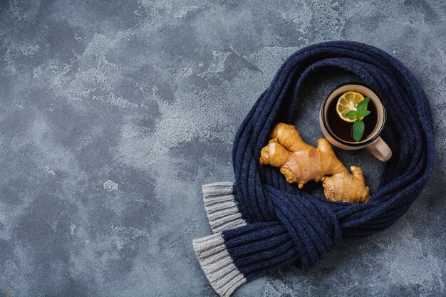 Cup of hot Ginger tea with lemon and honey on dark gray surface