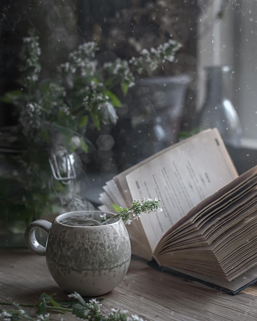 cup of hot herbal tea on kitchen table background