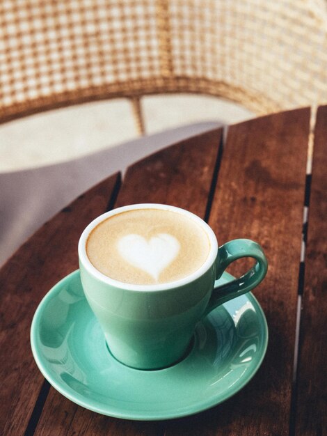 A cup of hot latte coffee on the table for breakfast