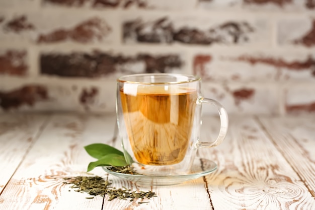 Cup of hot tea on wooden table