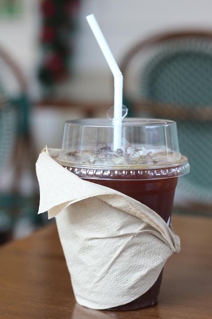 Photo cup of iced coffee with straw