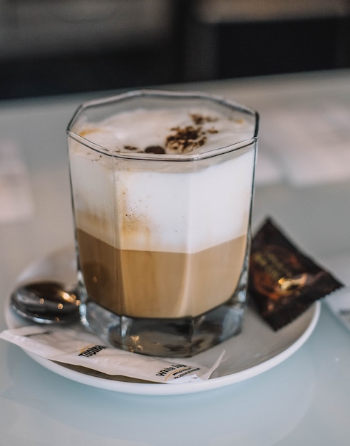 A cup of Italian latte on the table of a fancy restaurant