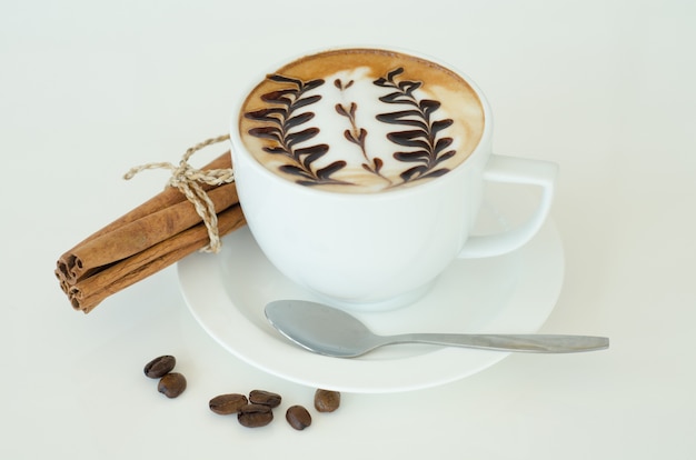 a cup of latte art on white background