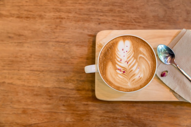 cup of latte coffee  on wood plate