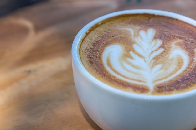 cup of latte coffee on wood table