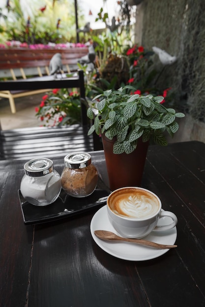 Cup of latte coffee on wooden table