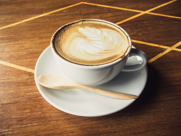 Cup of latte coffee on wooden