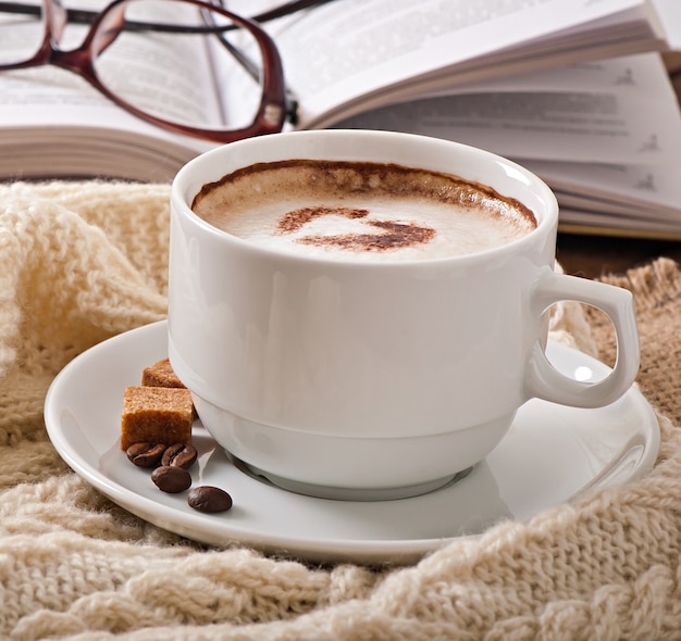 Cup of latte on the old wooden background