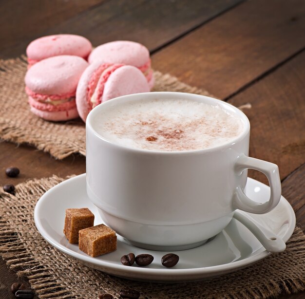 Cup of latte on the old wooden background