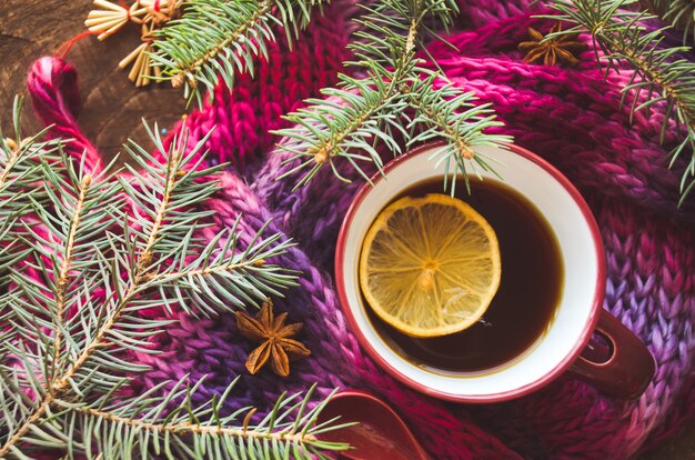 Cup of lemon tea covered with scarf