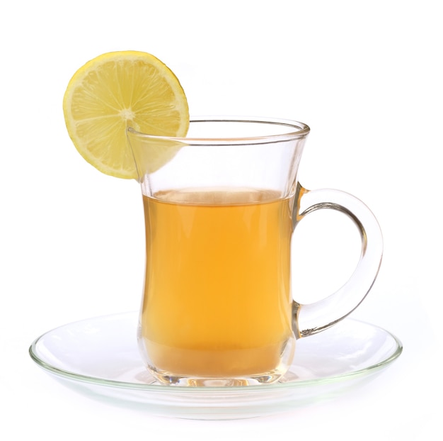 Cup of lemon tea with sliced lemon over white background