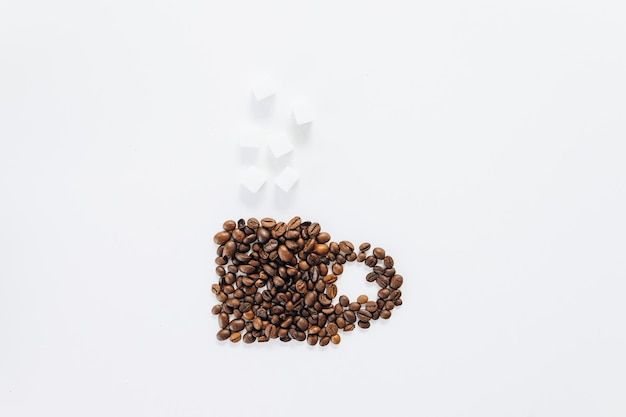 Cup made on coffee beans on white background