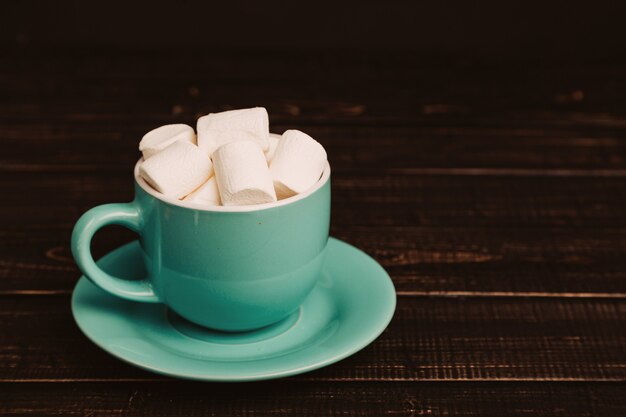 Cup of marshmallow on the dark background