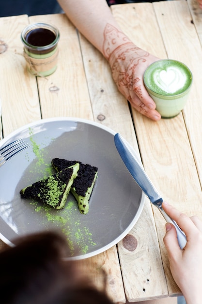 Cup of matcha green tea and cake with green matcha ice cream