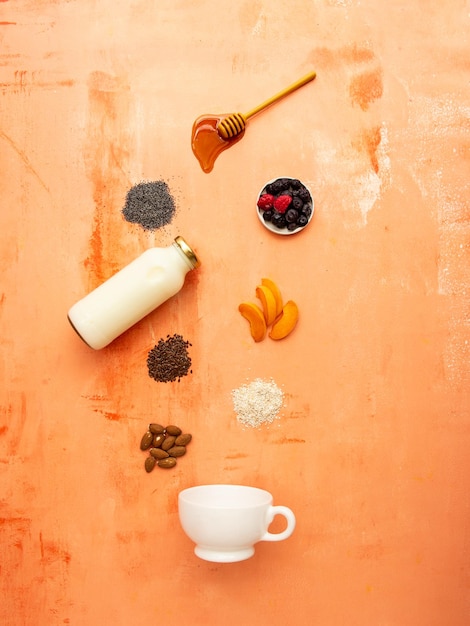 Foto una tazza di latte e una bottiglia di latte sono su un tavolo con altri oggetti.