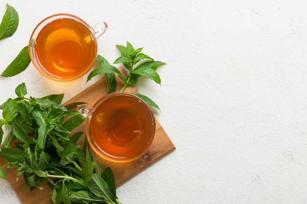 Cup of mint tea on table background Green tea with fresh mint top view with copy space