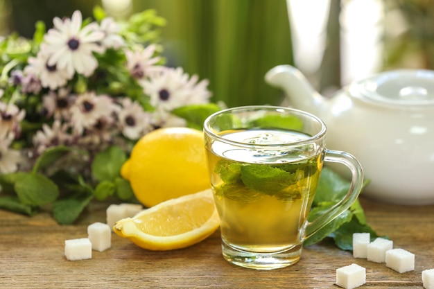 Cup of mint tea on table