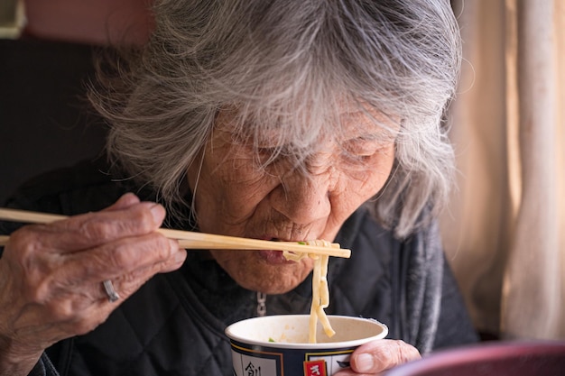 Cup noodle and old japanese woman
