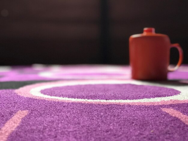 Cup orange and purple mat background with natural lighting beautiful orange cup