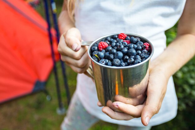 Cup of raspberries and blueberries