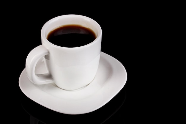 A cup of strong coffee isolated on black