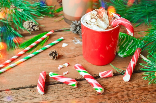 Cup of tasty cocoa on blurred background Hot chocolate with peppermint candies