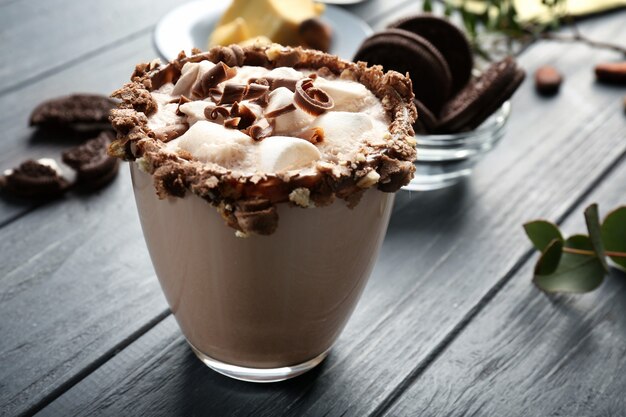 Cup of tasty cocoa drink with marshmallow on wooden table