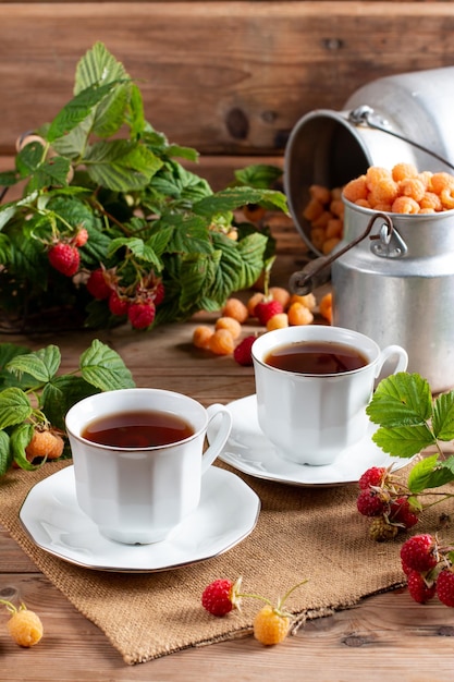 Cup of tasty raspberry tea on wooden table Useful drink for health Herbal tea Traditional medicine