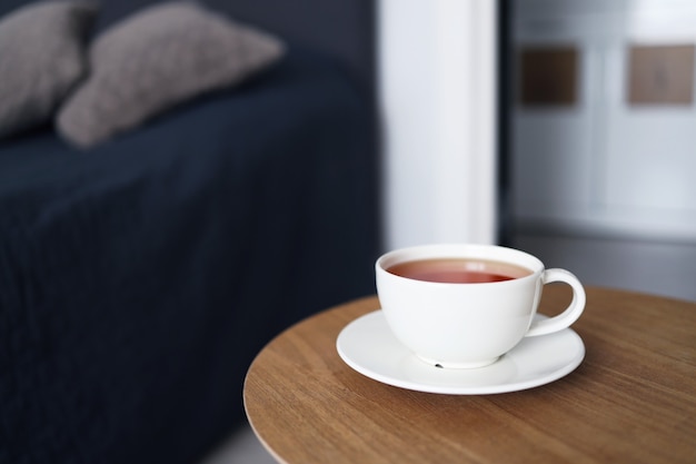 Cup of tea on the background of the bed. Good morning.