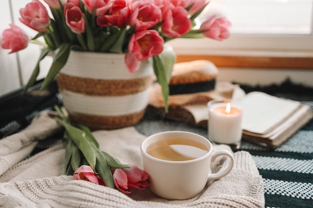 Чашка чая и корзина с эстетическим натюрмортом тюльпанов