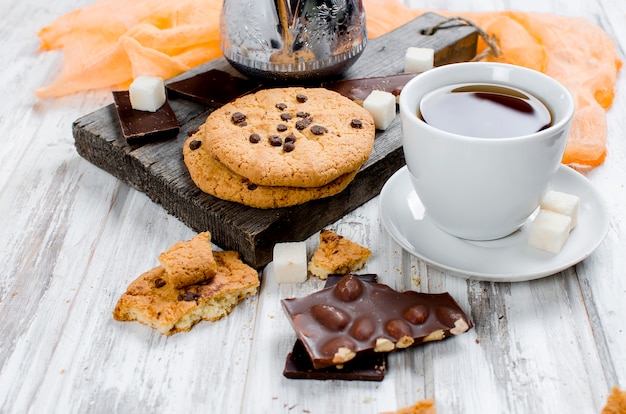 Cup of  tea, biscuits on white wooden table