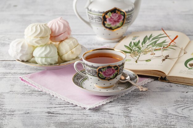 Cup of tea, book on wooden table